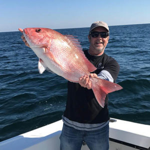 Gerald Jones holding a Snapper he caught while deep sea fishing