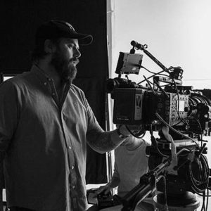 Director Jason Whitbeck adjusts a camera during video shoot
